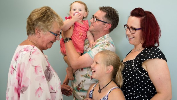 Eunice Lee (left), with her son, Mark Lee, who has successfully completed a gene therapy trial for haemophilia, and her granddaughters, Grace, 10, and Violet ,18 months, and her daughter-in-law, Shannon Salo, at the Charles Perkins Centre at RPA in Sydney.  