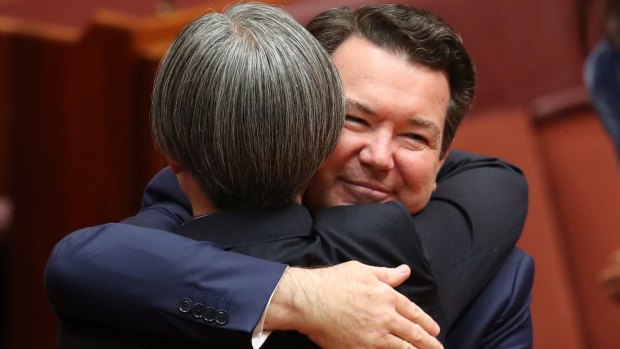 Senator Penny Wong is hugged by co-sponsor Senator Dean Smith earlier this month.