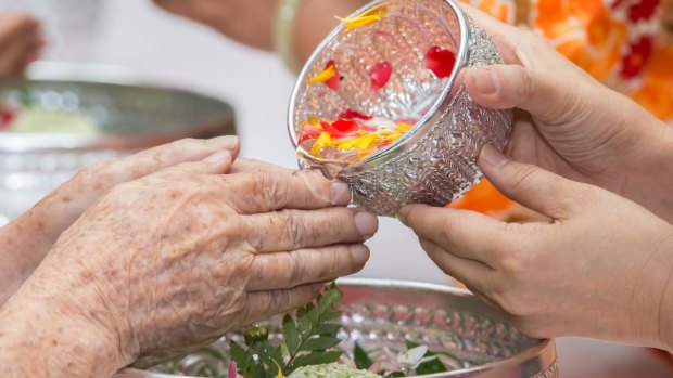 Pouring water on the hands of revered elders gives a blessing.