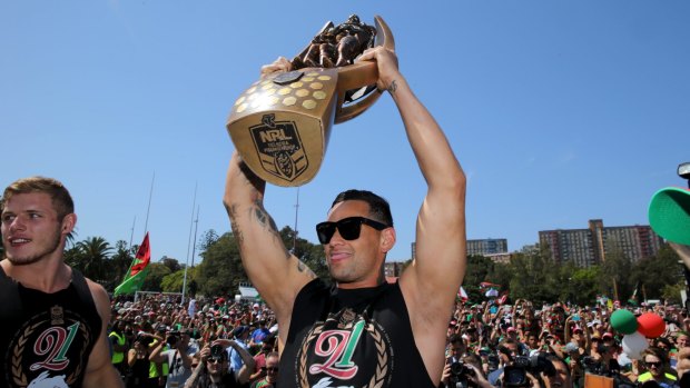 Victorious skipper: Rabbitohs captain John Sutton holds the trophy aloft for fans the day after last year's grand final win over Canterbury.