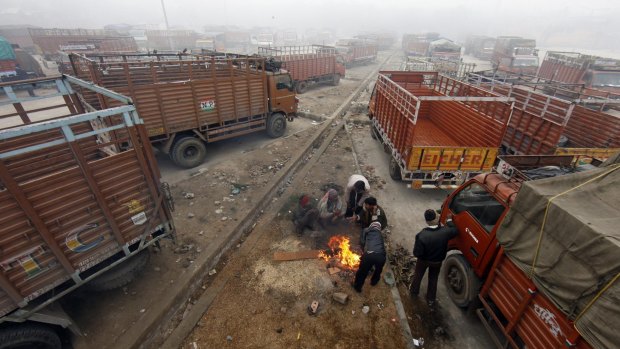 Truck drivers warm themselves by a fire in the Indian capital, New Delhi.