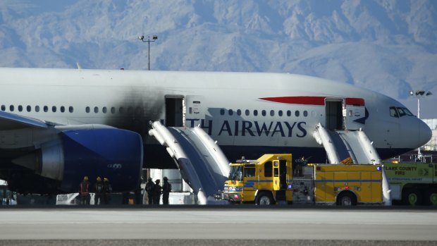The fuselage of the BA Boeing shows smoke damage. 
