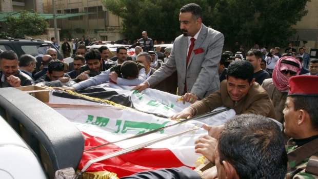 Men mourn during the funeral of  Iraqi Sunni leader Sheikh Qasim al-Janabi and his son Mohammad.