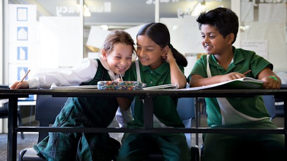 Year 3 students from St. Anthony's in Girraween (from left) Zoe Atkinson, 8, Mokshada Rane, 8, and Aryan Sawant, 8 sit down to their 2016 NAPLAN tests.
