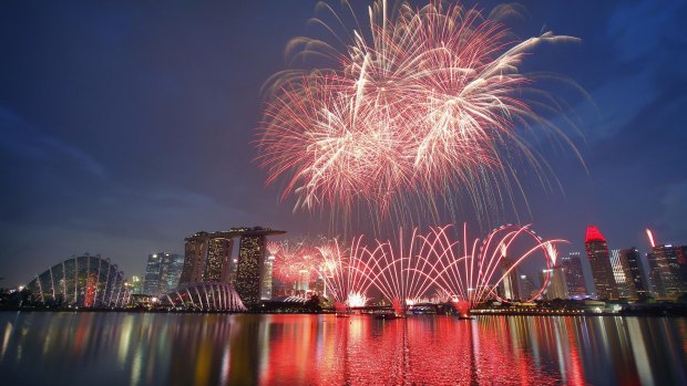 Fireworks explode above Singapore's financial district as part of celebrations to mark the nation's 50th year of independence.