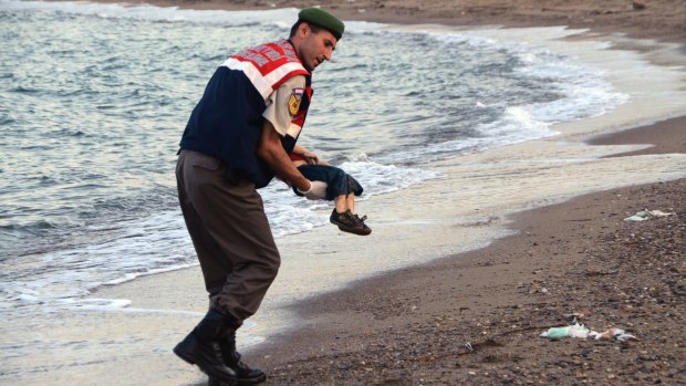 A police officer carries three-year-old Aylan Kurdi after he drowned near the Turkish resort of Bodrum.