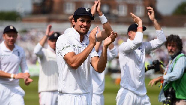 Relief: Alastair Cook celebrates with England teammates after regaining the Ashes at Nottingham.
