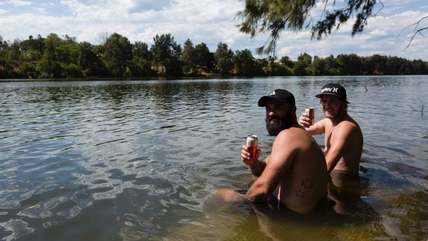 Friends cool off in the Nepean River in Penrith on Sunday. 
