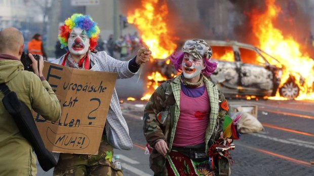 Demonstrators dressed as clowns protesting against government austerity and capitalism in Frankfurt, Germany.