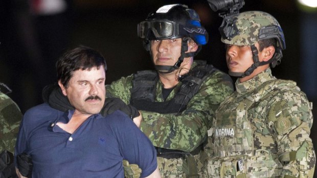 Joaquin "El Chapo" Guzman is made to face the press as he is escorted by Mexican soldiers and marines in Mexico City in January following his recapture six months after escaping from a maximum security prison. 