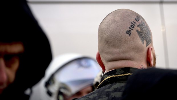 Members of right-wing groups gather in front of Cologne's main railway station on Saturday to protest against the New Year's Eve sex attacks.