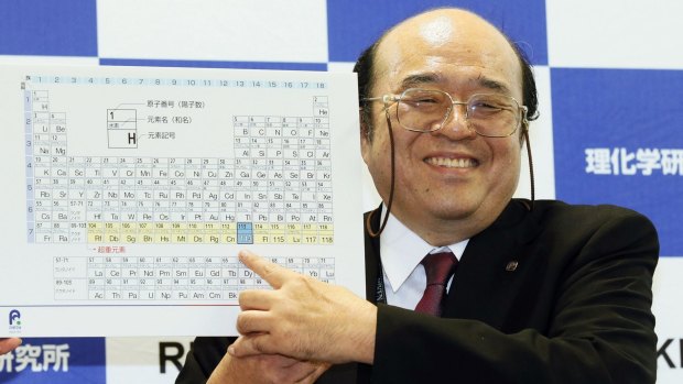Kosuke Morita of Riken Nishina Center for Accelerator-Based Science points out the new elements added to the periodic table of the elements during a press conference.