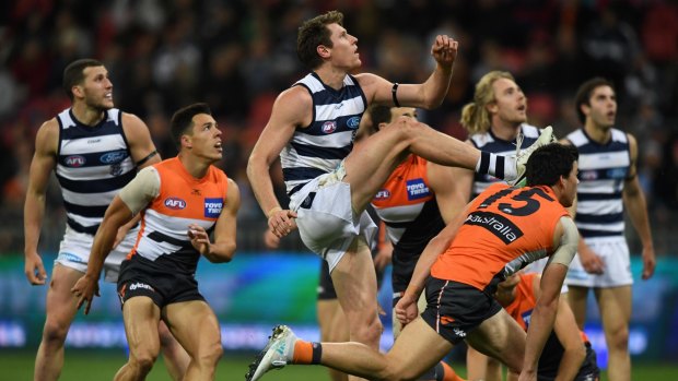 Eyes up: Geelong's Mark Blicavs gets a kick away against GWS.