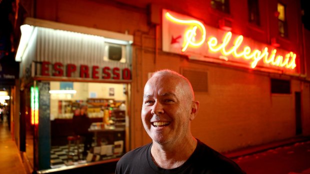 Filmmaker Lawrence Johnston takes in the neon glow at Melbourne espresso bar Pelligrini's.