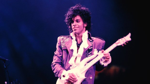 Prince performs onstage during his 1984 Purple Rain tour.