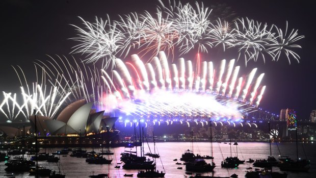 Fireworks explode over the Sydney Harbour Bridge and Opera House during New Year's Eve celebrations.