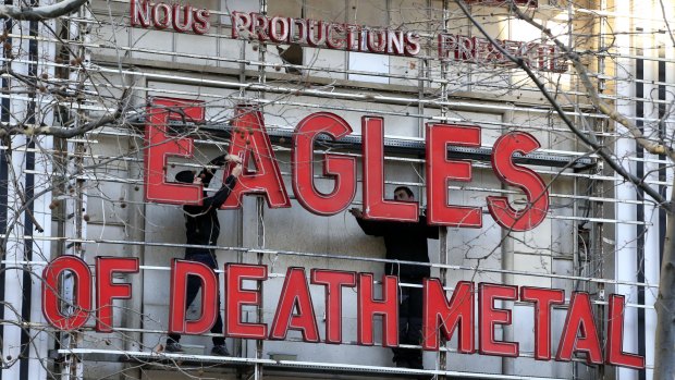 Workers set up a sign before Tuesday's concert by Eagles of Death Metal. Survivors of November's deadly attacks have opened up to a French terrorism commission before the highly charged concert.