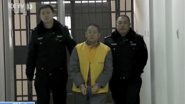 Ezubao owner Ding Ning escorted by policemen in an unknown location in an undated image taken from CCTV.