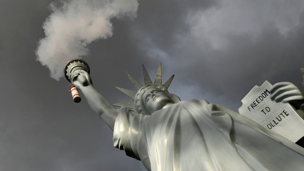 A replica of the Statue of Liberty by Danish artist Jens Galschiot emits smoke in a park outside the 23rd UN Conference of the Parties (COP) in Bonn, Germany, on Friday.