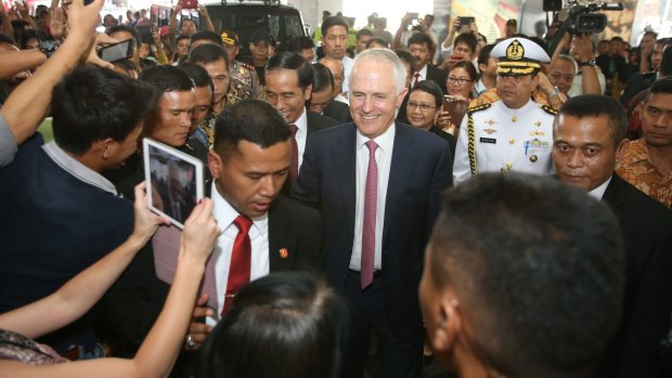 Prime Minister Malcolm Turnbull with Indonesian president Joko Widodo in Jakarta during a stroll through a local textile market.