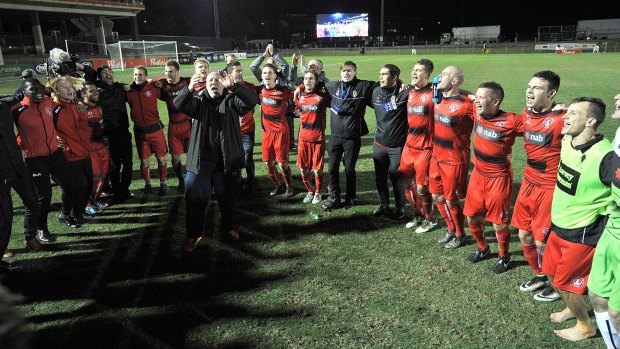 Redlands United celebrate their epic - if unlikely - victory against Adelaide United at Perry Park.
