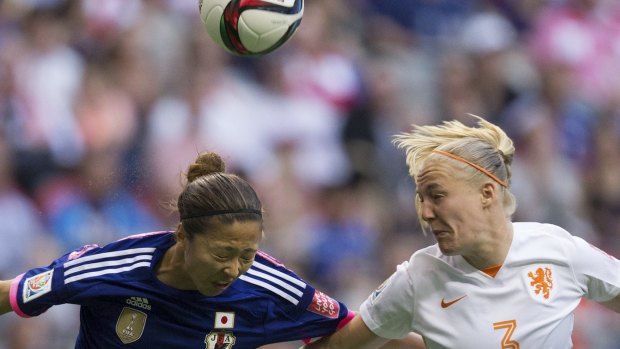 Netherlands' Stefanie van der Gragt, right, and Japan's Yuki Ogimi contest for the ball.