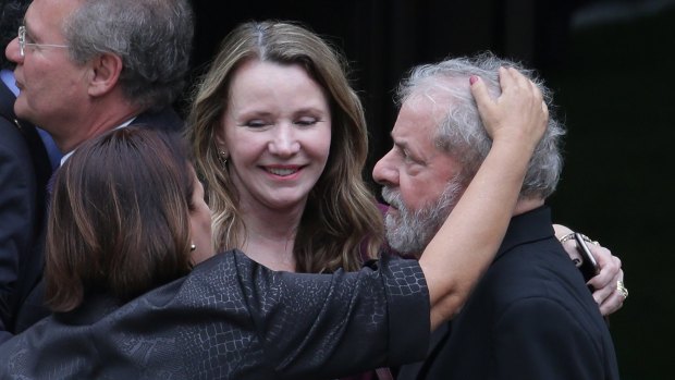 Senators Fatima Bezerra, left front, and Vanessa Graziotin, embrace Mr Lula in Brasilia this month.