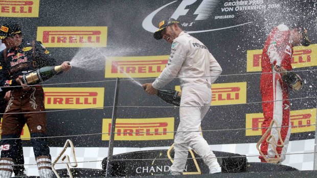 Red Bull driver Max Verstappen (left), Mercedes driver winner Lewis Hamilton (centre) and Ferrari driver Kimi Raikkonen celebrate after the Austrian Formula One Grand Prix.