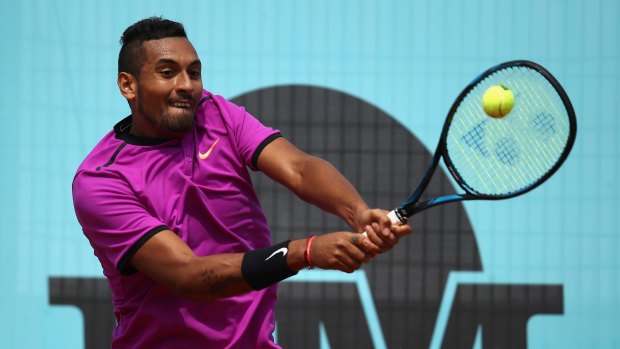 Nick Kyrgios plays a backhand in his match against Ryan Harrison of USA during day five of the Mutua Madrid Open.