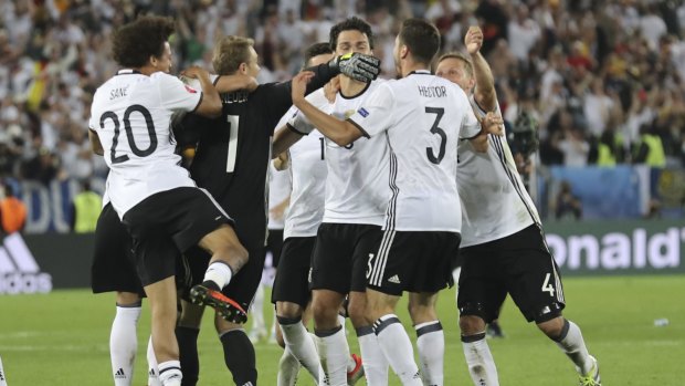 Jubilation: Germany's players celebrate after Jonas Hector scored the winning penalty.