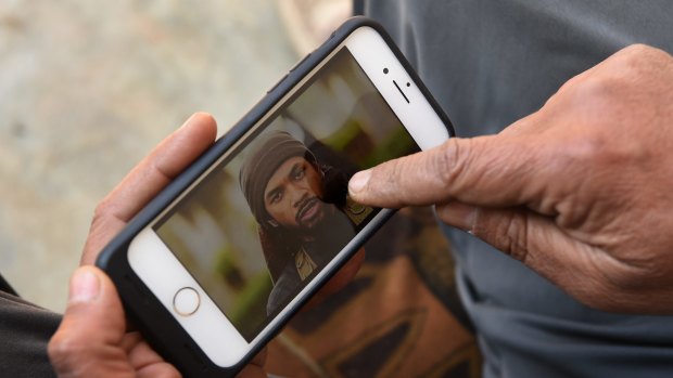 Yusuf Abbas, 51, points to a photo of Neil Prakash identifying him as the foreign fighter he saw in Mosul.