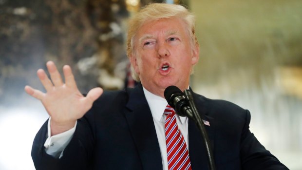 US President Donald Trump speaks to the media in the lobby of Trump Tower in New York.