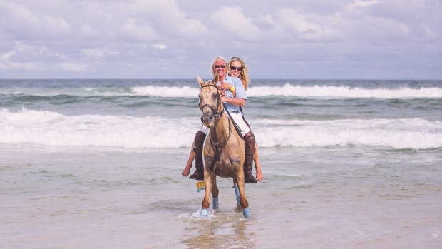 Breaking in: Chris Murphy and wife Caroline ride the waves.