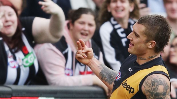 The Tigers' Dustin Martin gestures to Magpie fans after a goal in August.