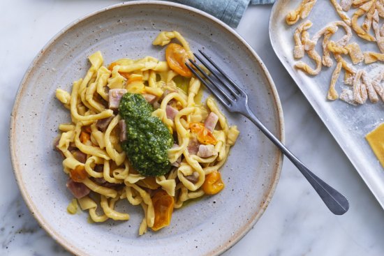 Giovanni Pilu's pasta twists tossed though a tomato sauce with tuna cubes and finished with a dollop of cheese-free pesto.