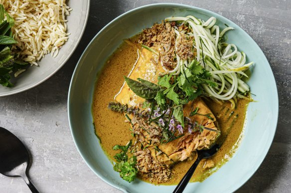 Salmon curry served with shredded papaya on the side (optional).