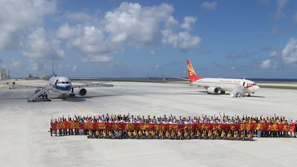 A photo released by China's Xinhua News Agency shows a pair of Chinese civilian jet airliners after landing at the newly created island in a test of its airstrip.