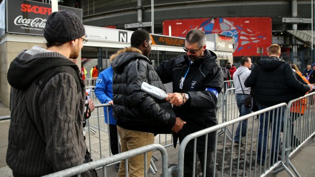 Security: Rugby fans are scanned and searched as they approach the turnstyles into the Stade de France before the Six Nations match  between France and Italy.
