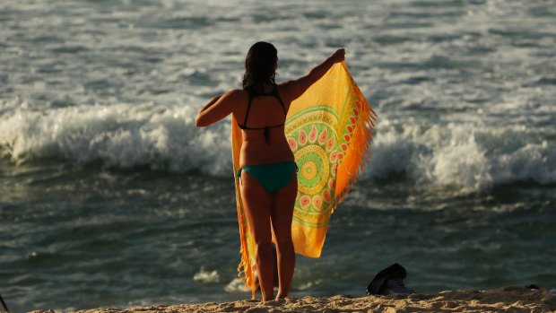 A woman prepares to enjoy the sun during a warm spring morning at Bondi Beach on Wednesday.