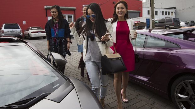 From left: Loretta Lai, Chelsea Jiang and Diana Wang at a reception at a Lamborghini dealership in Vancouver.