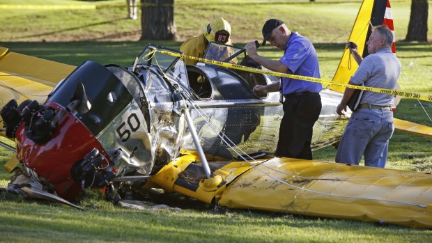 Officials work on the plane.