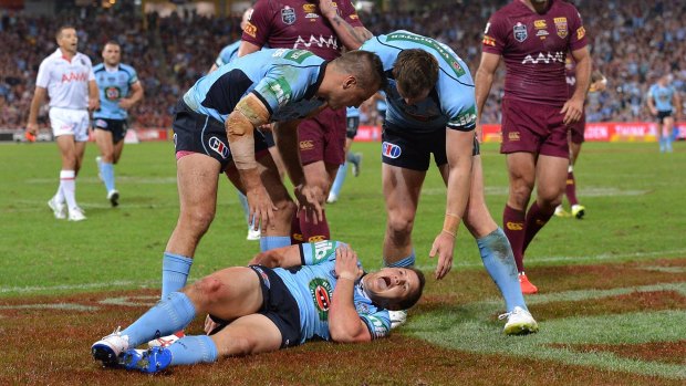 Agony: Brett Morris screams in pain after injuring himself scoring a try during game one of the State of Origin series in 2014.