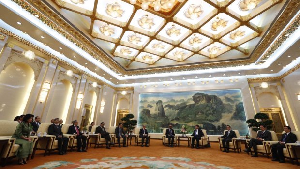 China's President Xi Jinping (fourth right) meets guests at the Asian Infrastructure Investment Bank (AIIB) launch ceremony in the Great Hall of the People in Beijing in October last year.