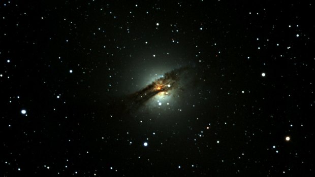 The Centaurus A galaxy. This image shows it being orbited by a second, smaller galaxy, which it is in the process of consuming.
