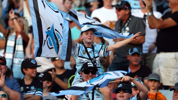Fans showing true colours: Sharks supporters during the round 24 NRL match between the Cronulla Sharks and the Wests Tigers at Remondis Stadium.