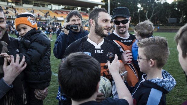 Mobbed: Tigers hooker Robbie Farah is cheered as he walks off Leichhardt Oval on Saturday.