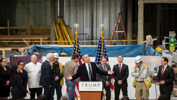 Donald Trump inside the under-construction Trump International Hotel in Washington in March 2016. In 2014, Deutsche Bank agreed to lend the Trump Organisation up to $US170 million to finance the gut renovation of the hotel.  