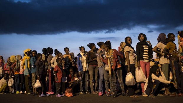 Hundreds of migrants from sub-Saharan Africa arrive at Augusta port in Sicily last year. 