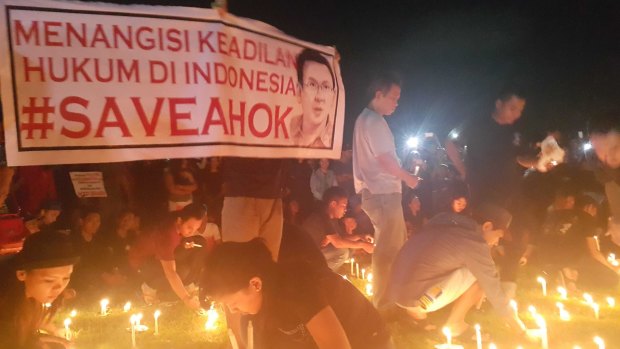 Supporters conduct a candlelit vigil in Bali in support of Ahok. The sign reads "Bitter over the lack of justice in Indonesian law".