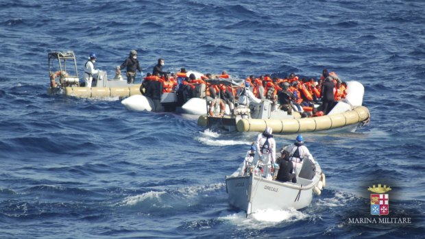 Migrants are rescued by Italian Navy personnel off the island of Lampedusa, Italy, on Wednesday.